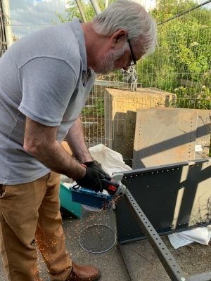 Peter G4WLI
Peter cutting shelving to size with a grinder
